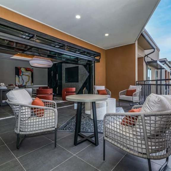 The community balcony with tables and chairs at Magnolia on the Green. 