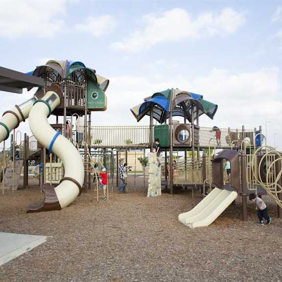 A playground with a slide, swings, and a climbing structure.
