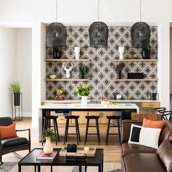 an open concept living room and dining area with a white dining table and rattan chairs at Onyx at Westgate Apartments, Glendale, AZ, 85305