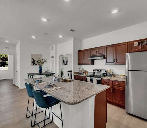 a kitchen with a counter top next to a stove top oven