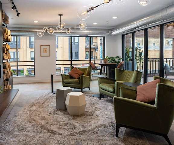 a living room with green chairs and a rug  at Kesler Apartments in Downtown Fargo, Fargo, North Dakota, 58102