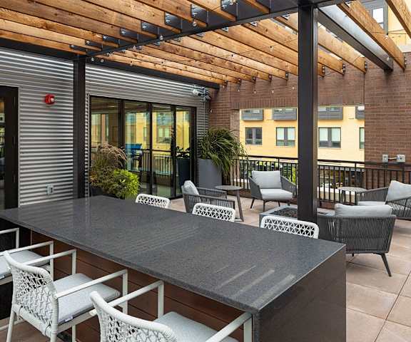 A patio with a table and chairs under a wooden roof  at Kesler Apartments in Downtown Fargo, Fargo, North Dakota, 58102