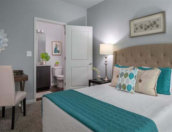 a bedroom with a bed and a bathroom