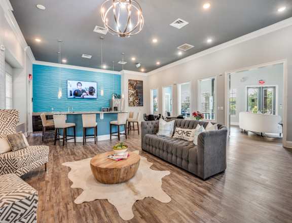 A living room with a blue accent wall and a television.