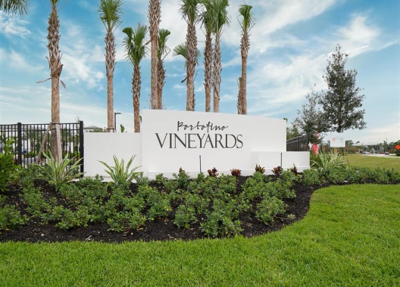 a sign that is in the middle of a grassy area  at The Grove at Portofino Vineyards, Fort Myers, FL