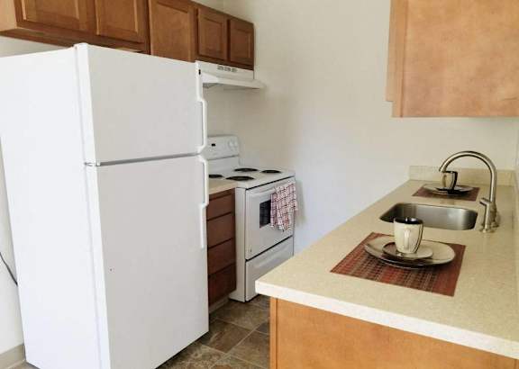 A room with a carpeted floor and a brown cabinet.