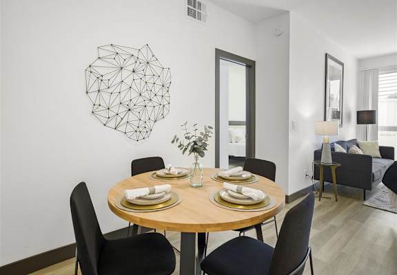 a dining room with a table and chairs at Enclave, Paramount California
