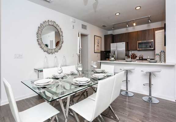 a dining room with a glass table and chairs at Shingle Creek, Kissimmee, Florida
