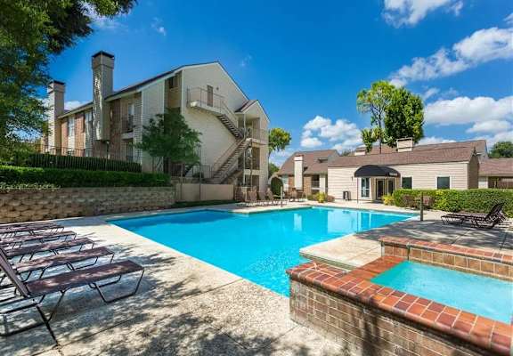 our apartments have a large pool and a patio with chairs