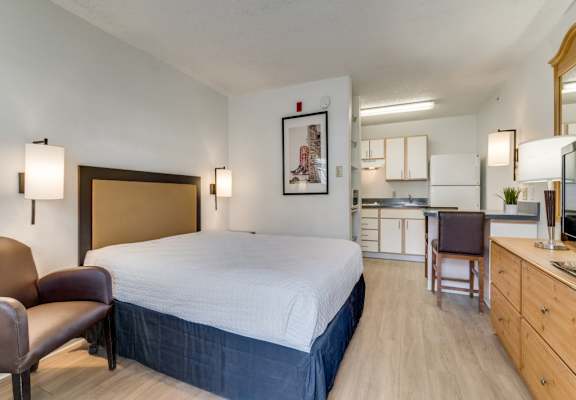 a hotel room with a bed and a kitchen  at Waterford Studios, Texas, 78758