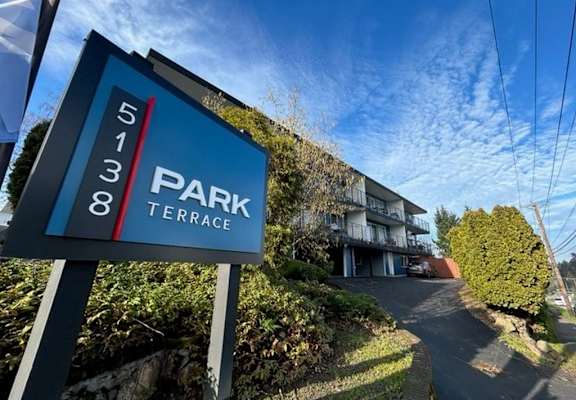 A sign for Park Terrace stands in front of a building.