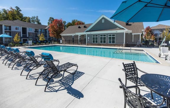 our apartments have a large pool with chairs and umbrellas at The Atlantic Mountain Island, Charlotte, NC