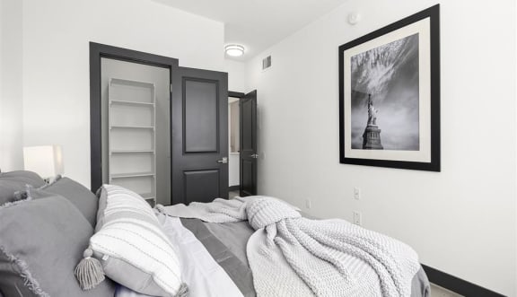 a bedroom with a bed and a door to a bathroom at Enclave, Paramount