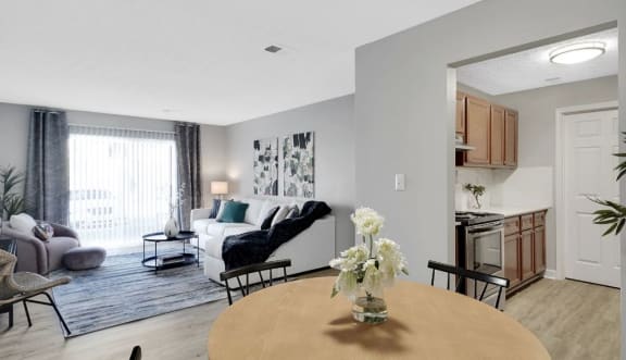 a living room with a couch and a table with a vase of flowers on it