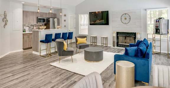 a living room with a fireplace and a table with chairsat The Hub at 934 Apartments, Georgia, 30349