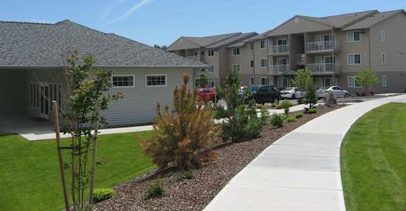 A residential area with houses and a sidewalk at Forest Creek Apartments in Spokane, WA