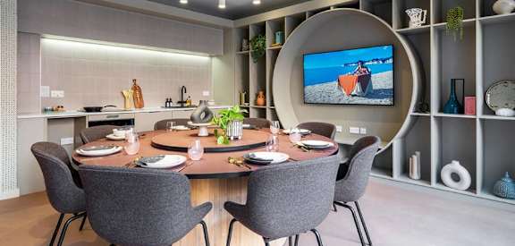 a dining room with a table and chairs and a tv