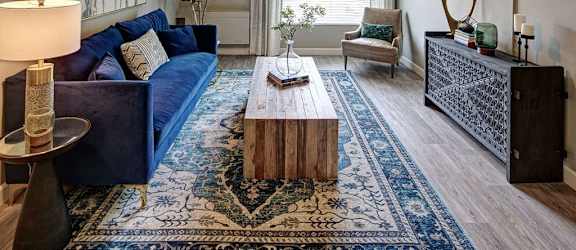 a living room with a blue couch and a coffee table
