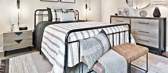 a bedroom with a bed and a mirror