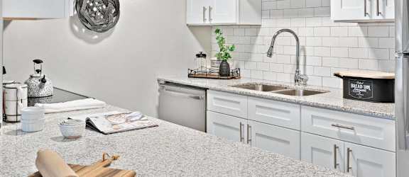 a kitchen with a large counter top and a sink