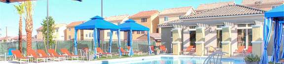 Pool, outdoor furniture, and cabanas on a beautiful day at CHANDLER APARTMENT HOMES, Las Vegas, Nevada