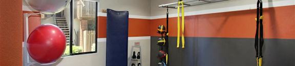 Fitness Room with resistance bands, kettle, inflatable fitness, and medicine balls at CASA GRANDE APARTMENT HOMES, California