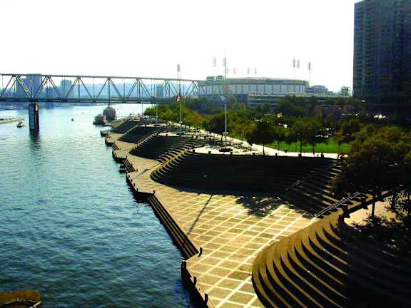 A long walkway runs along a body of water.at Sky Central, Cincinnati