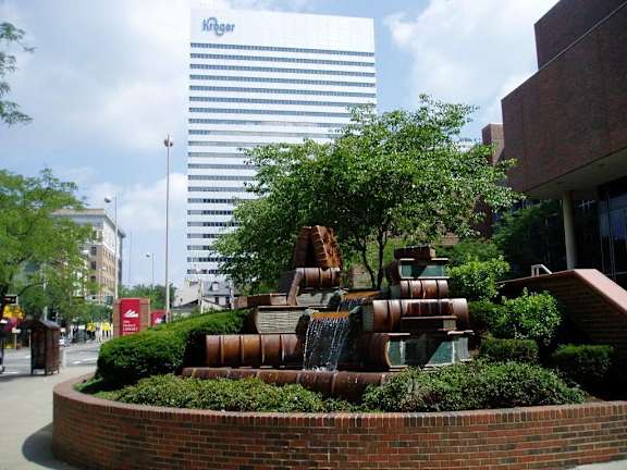 A fountain in a garden in front of a building with a sign that says Kskager.at Sky Central, Cincinnati, 45202