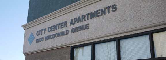A building with a sign that says City Center Apartments.