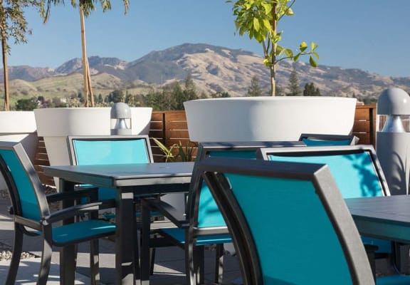 Outdoor common area with chairs and cafe tables at Lyric, Walnut Creek, 94596