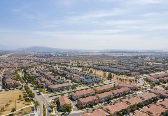 an aerial view of a city with houses and a highway at The Vines at Riverpark, LLC, California