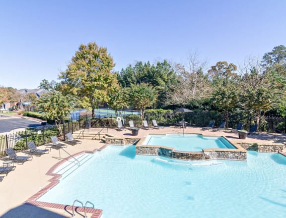 Resort Style Pool with Soothing Waterfall Features and Sundeck with Poolside Wi-Fi Access at Sugarloaf Crossing Apartments, Lawrenceville, GA 30046