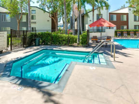 Dog Friendly Apartments in Ontario CA - Avante - Gated Hot Tub Surrounded by Palm Trees