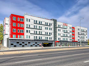 A modern building with a red and white facade.