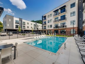 a swimming pool in front of an apartment building