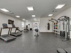 a gym with cardio equipment and weights in a building