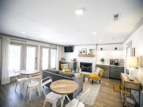 Resident clubroom with tables, couches, coffee bar and TV