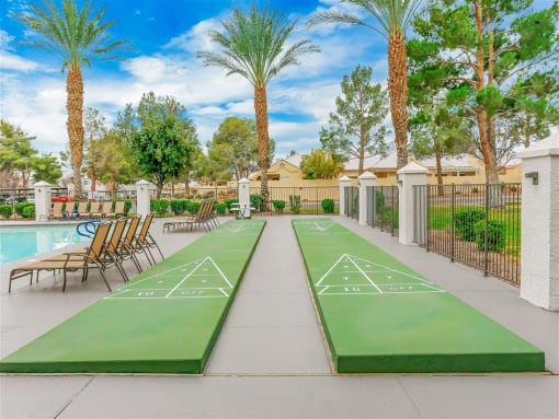 Shuffleboard poolside at Country Club at The Meadows Senior Apartments in Las Vegas, NV, For Rent. Now leasing 1 and 2 bedroom apartments.