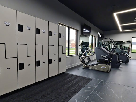 A gym with a row of lockers and a treadmill.