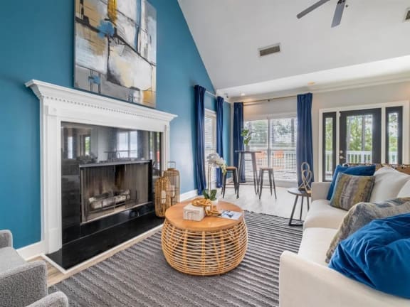 a living room with blue walls and a fireplace