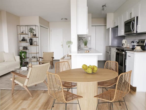 a living room and kitchen with a table and chairs