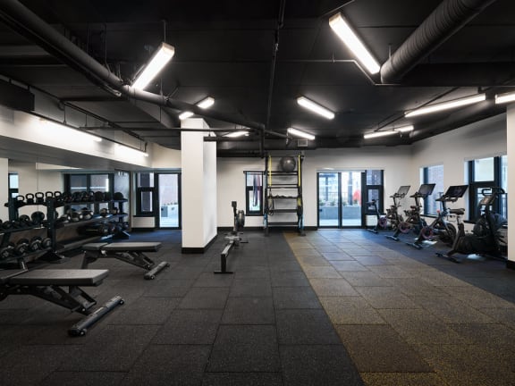 a photo of a gym with weights and other exercise equipment