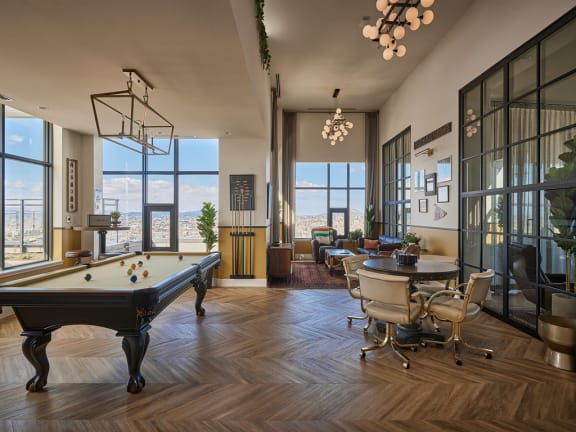 a living room filled with furniture and a pool table
