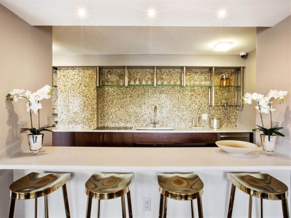 a kitchen with a counter and four stools
