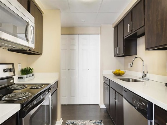 a kitchen with a stove top oven next to a sink Prospect Place Apartments in Hackensack, NJ