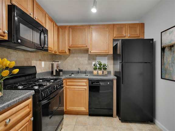 the kitchen has granite counter tops and wood cabinets