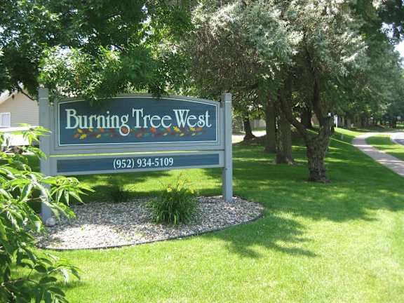 A sign for Burning Tree West with a phone number on it.