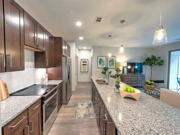 a large kitchen with granite counter tops and a long counter