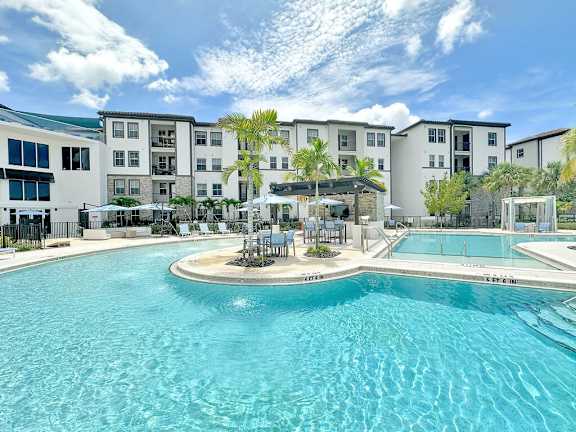  Beach-entry saltwater pool with sun shelves and cabanas