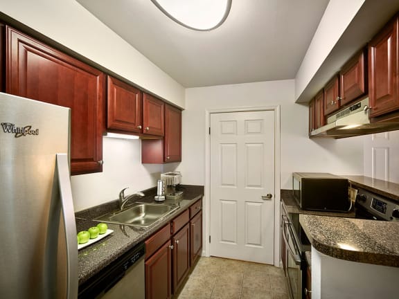 a kitchen with stainless steel appliances and granite counter tops at AVE Malvern, Malvern, Pennsylvania